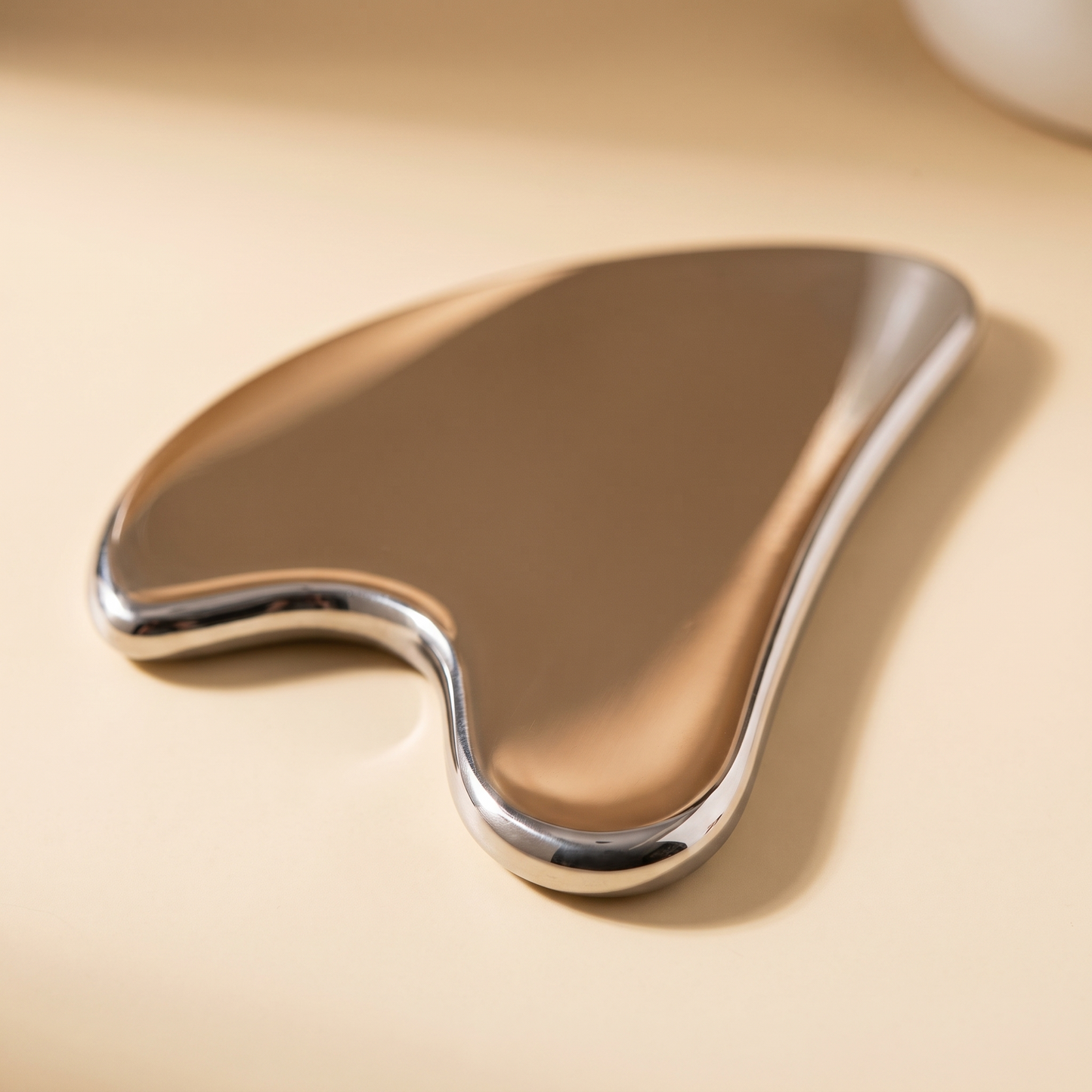Senvè Gua Sha macro detail of polished steel