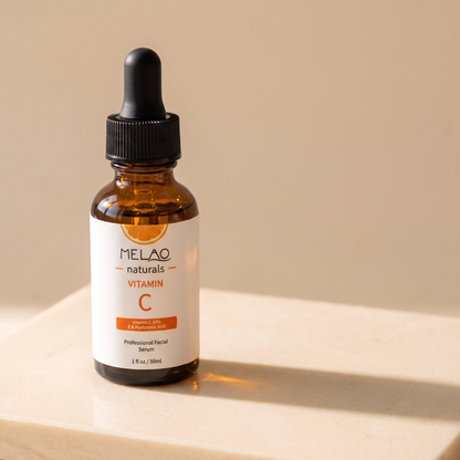 MELAO Naturals Vitamin C Serum bottle at an angle on a stone surface