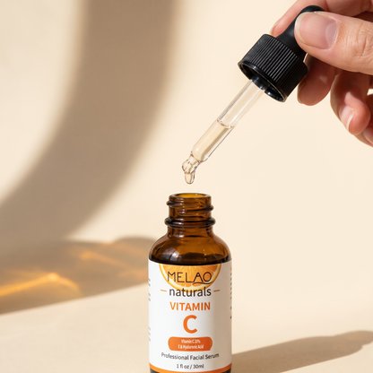 MELAO Naturals Vitamin C Serum dropper lifted from the bottle with a single drop