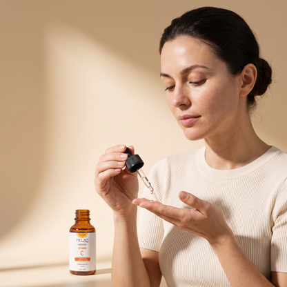 Woman dispensing MELAO Naturals Vitamin C Serum onto her fingertips